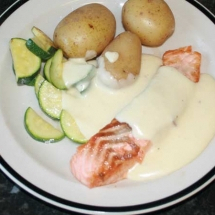 White sauce on salmon and vegetables