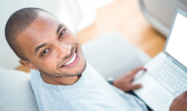 Cheerful man with laptop