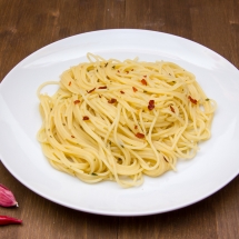 Spaghetti with garlic and chili peppers on wood