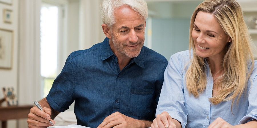 Mature couple doing family finances at home