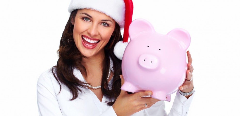 Woman in santa hat holding piggybank