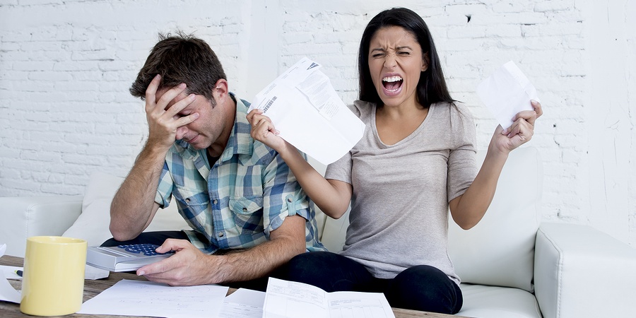 Angry couple going through bills