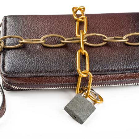 Clutch, chained with a padlock on a white background