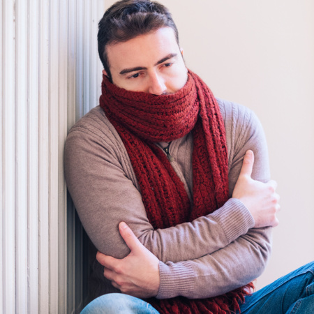 Man freezing and shivering at home because of winter cold