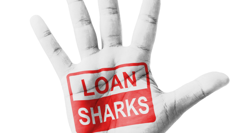 Open hand raised Loan Sharks sign painted