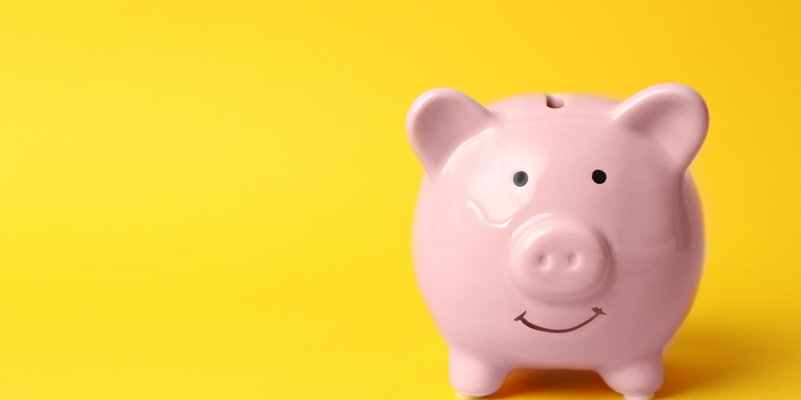 Piggy bank on yellow background