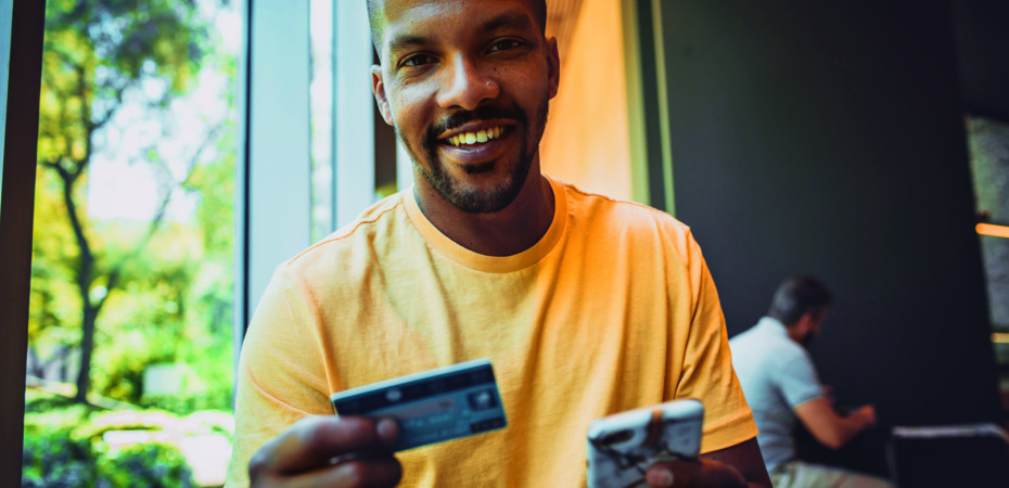 Man holding credit card and mobile phone