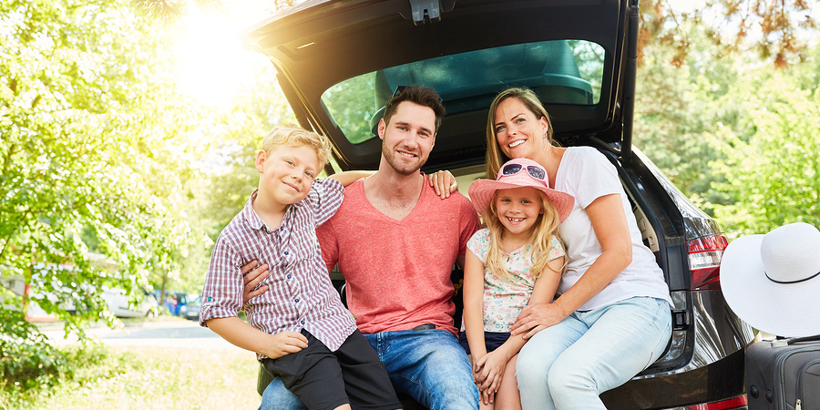 Happy family with car on holiday