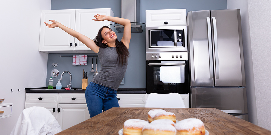 Young woman dancing in her kitchen