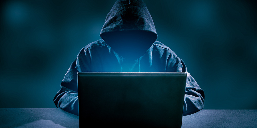 Internet scammer using laptop