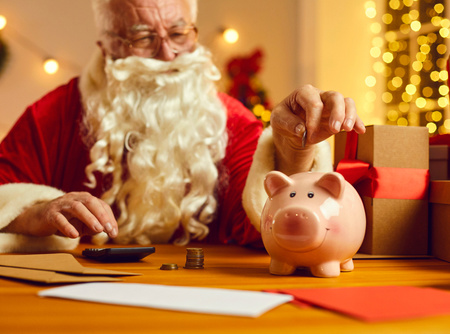 Father Christmas putting a coin in a piggybank