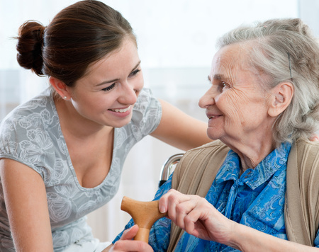 Older woman being cared for by younger woman