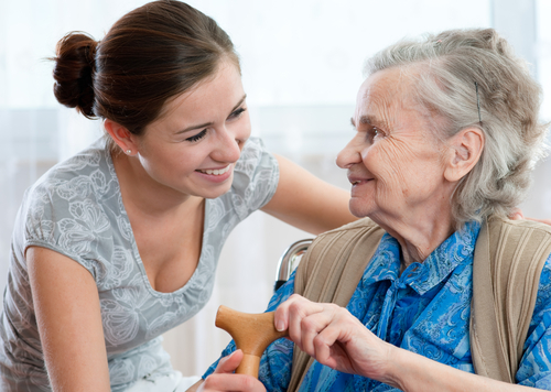 Older woman being cared for by younger woman