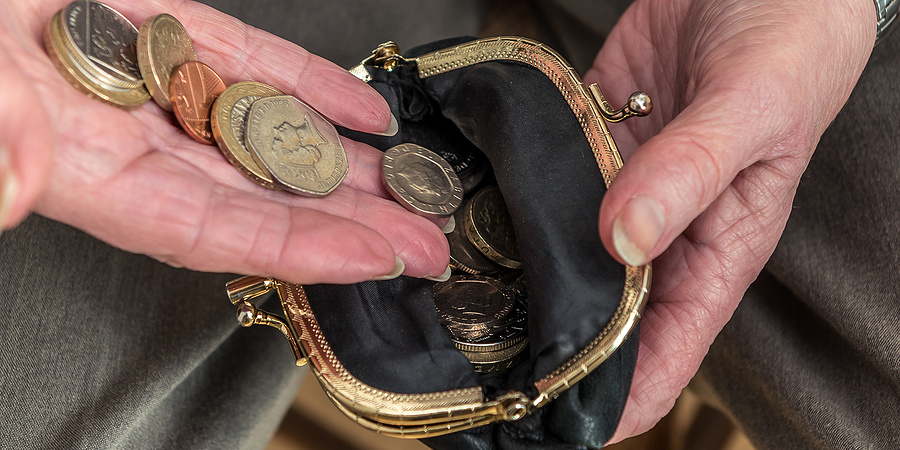 Female Pensioner Putting coins in Purse