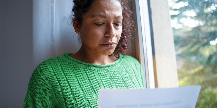 Worried woman reading a letter