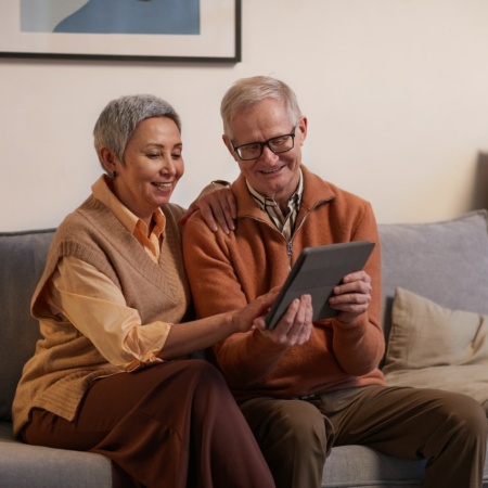 middle-aged couple looking at a tablet