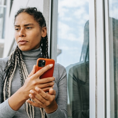 Worried woman with a mobile phone