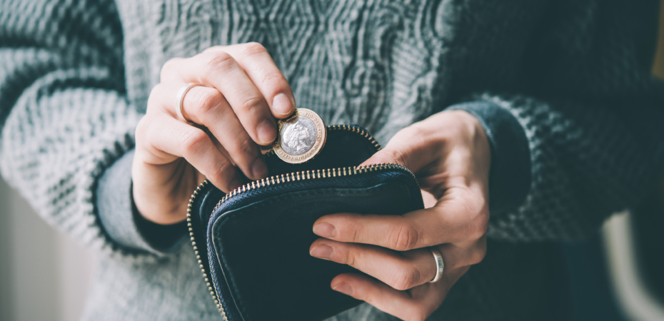 Woman taking pound coin from purse