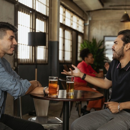 Men chatting and drinking in a pub