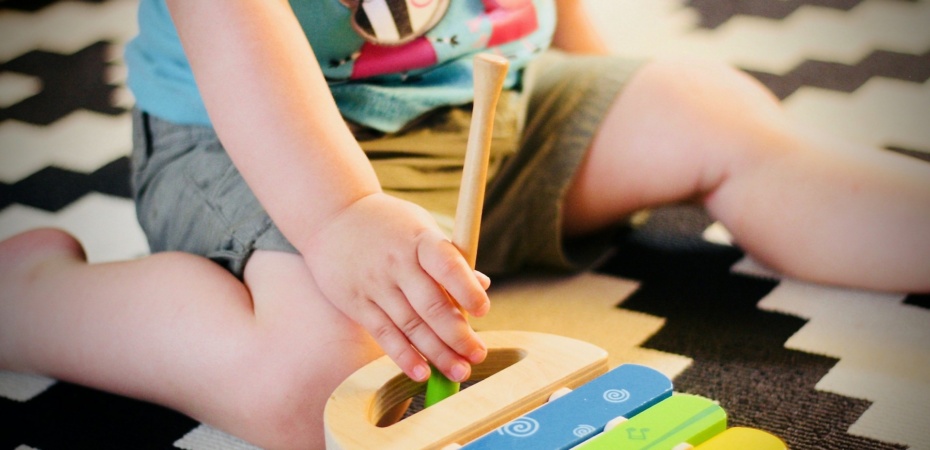 Toddler playing with a xylophone