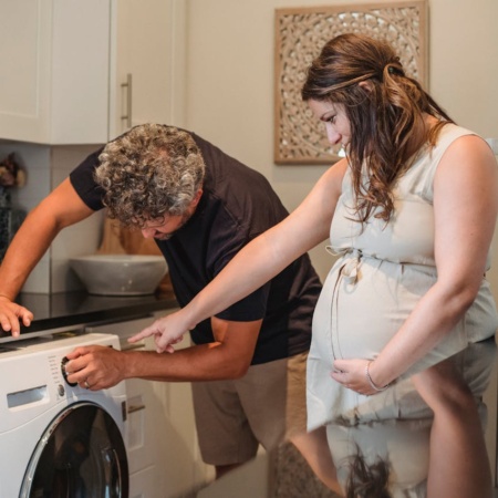 Couple using a washing machine